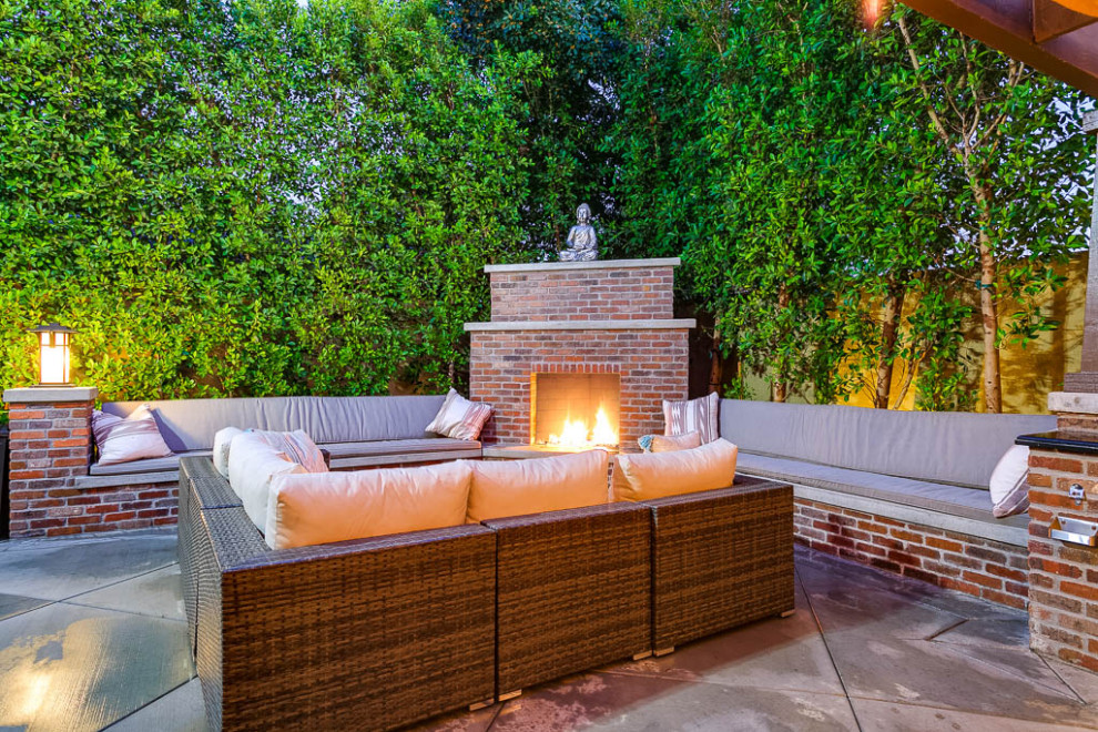 Patio - mid-sized traditional backyard concrete paver patio idea in Los Angeles with a fireplace and a pergola