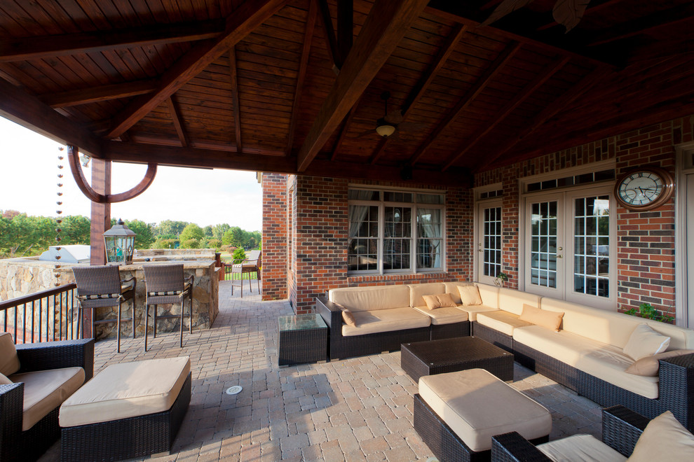 Inspiration for a contemporary concrete paver patio remodel in Charlotte with a roof extension