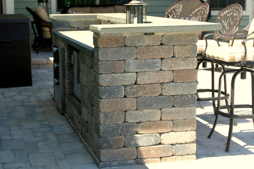 Inspiration for a contemporary backyard brick patio kitchen remodel in Chicago with no cover