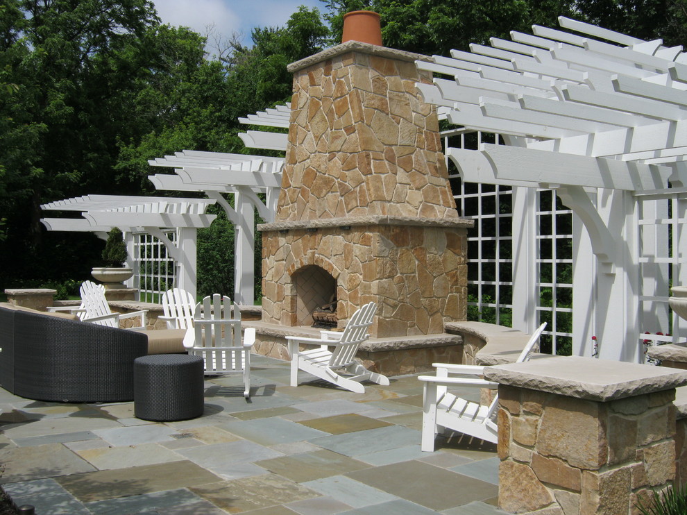 Mid-sized elegant backyard stone patio photo in Chicago with a fire pit and a pergola