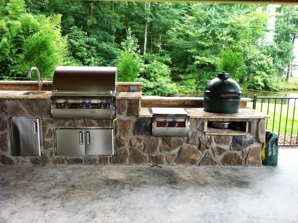 Inspiration for a large timeless backyard stone patio kitchen remodel in Atlanta with a gazebo