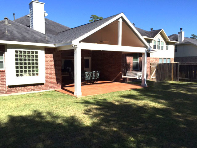This is an example of a medium sized contemporary back patio in Houston with stamped concrete and a roof extension.