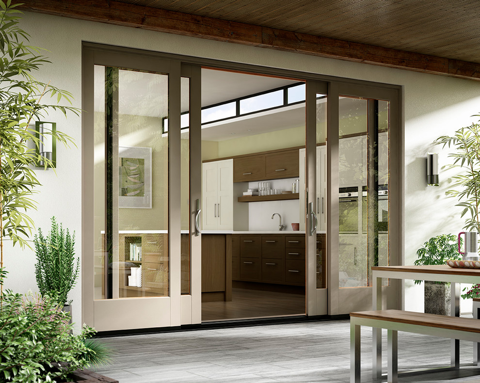 Example of a mid-sized trendy backyard patio kitchen design in Boise with a roof extension