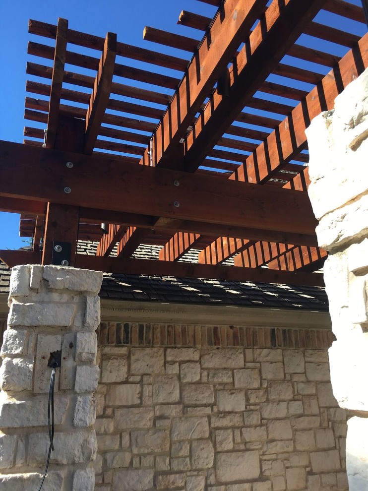 Example of a mid-sized transitional backyard brick patio design in Austin with a fire pit and a pergola