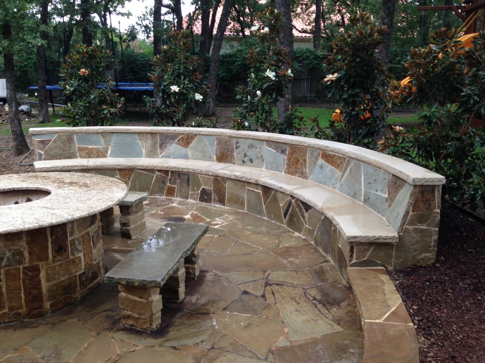 Large elegant backyard stone patio kitchen photo in Dallas with a gazebo