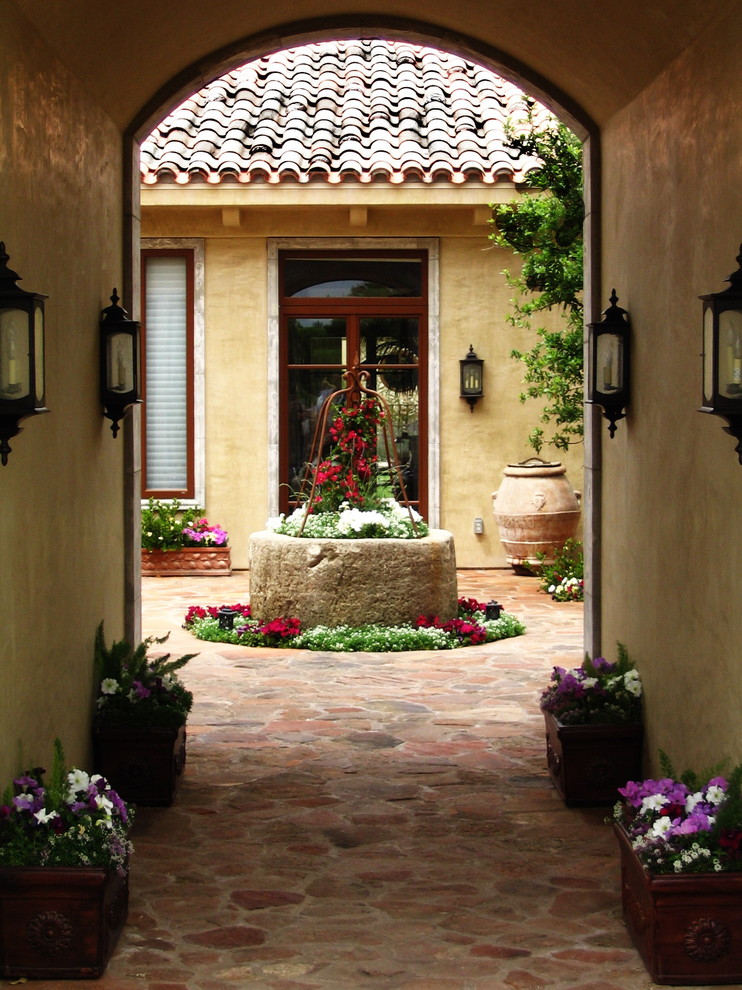 Example of a tuscan courtyard patio design in Vancouver