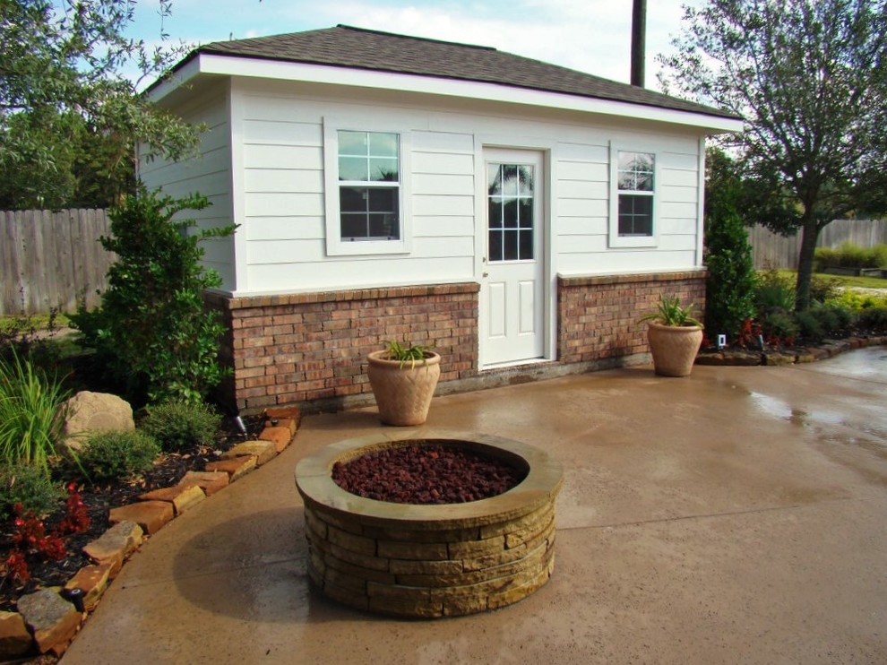 Example of a large minimalist backyard stamped concrete patio design in Houston with no cover