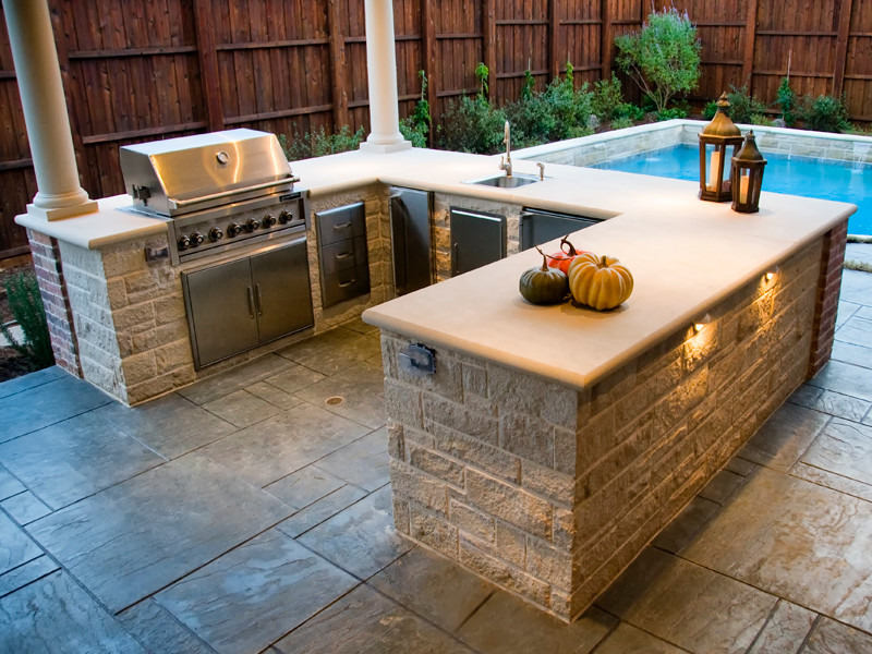 Photo of a medium sized classic back patio in Dallas with an outdoor kitchen, stamped concrete and a gazebo.