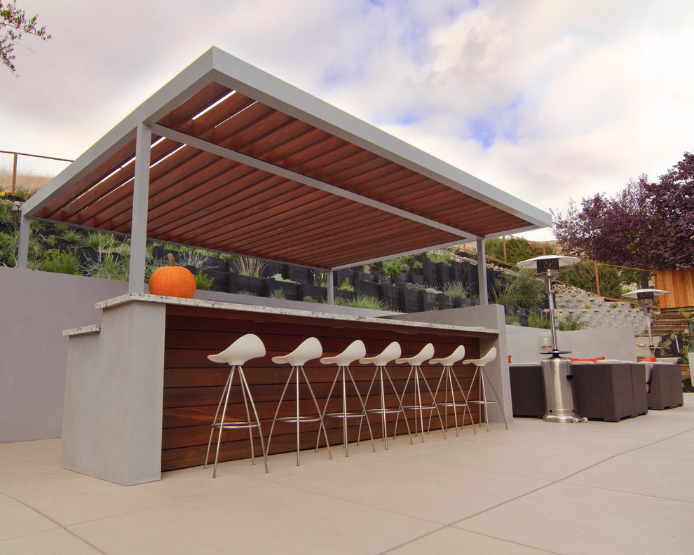 Example of a large trendy backyard concrete paver patio kitchen design in San Francisco with no cover