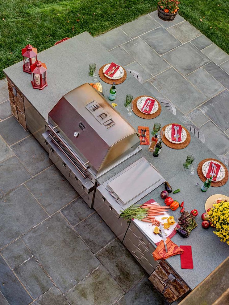 Medium sized rural back patio in New York with an outdoor kitchen.