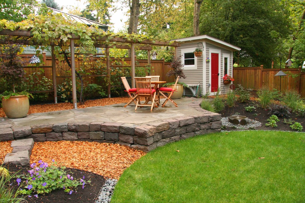 Immagine di un patio o portico chic dietro casa e di medie dimensioni con pavimentazioni in pietra naturale, fontane e un gazebo o capanno