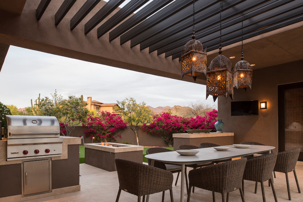 This is an example of a back patio in Phoenix with a pergola and a bbq area.