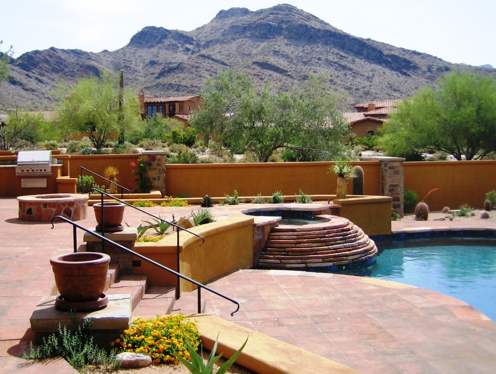 Photo of a mediterranean patio in Phoenix with a bbq area.