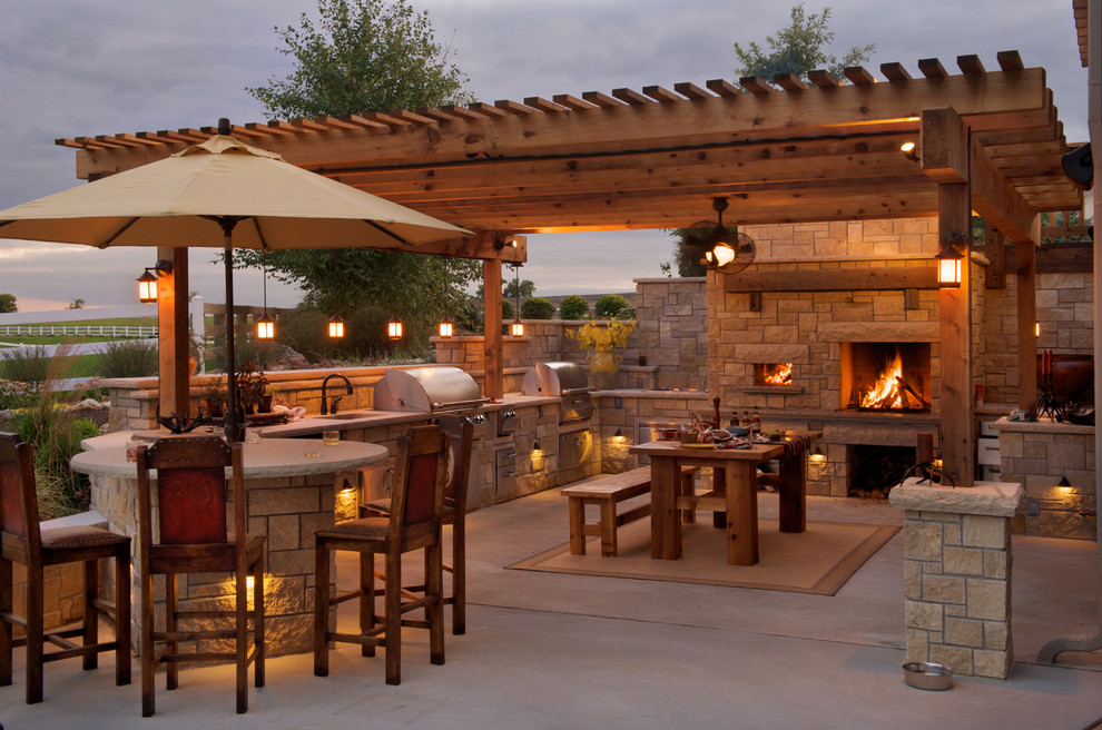 Cette image montre une terrasse arrière rustique de taille moyenne avec une cuisine d'été, une dalle de béton et un gazebo ou pavillon.