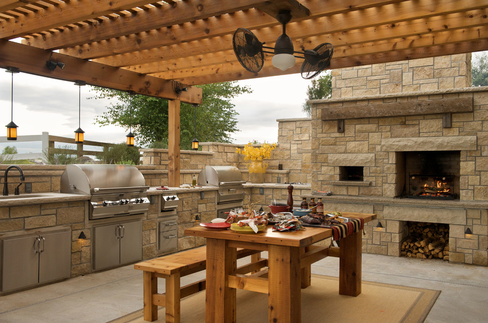 Design ideas for a medium sized farmhouse back patio in Kansas City with concrete slabs, a pergola and a bbq area.
