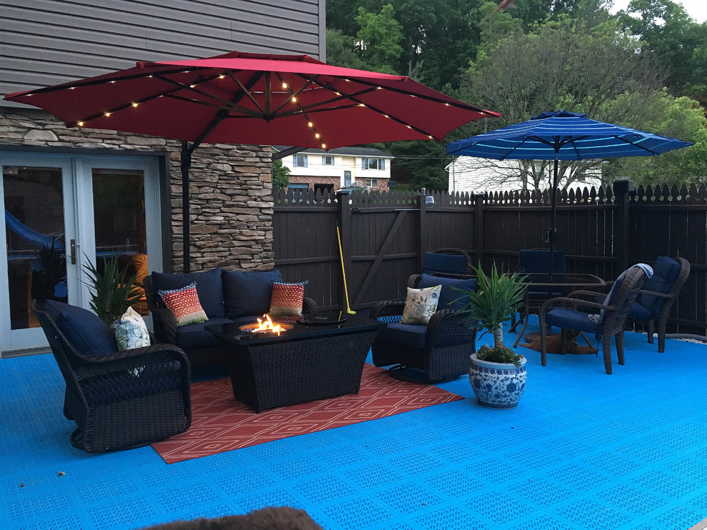 This is an example of a medium sized contemporary back patio in Minneapolis with tiled flooring, no cover and a fire feature.