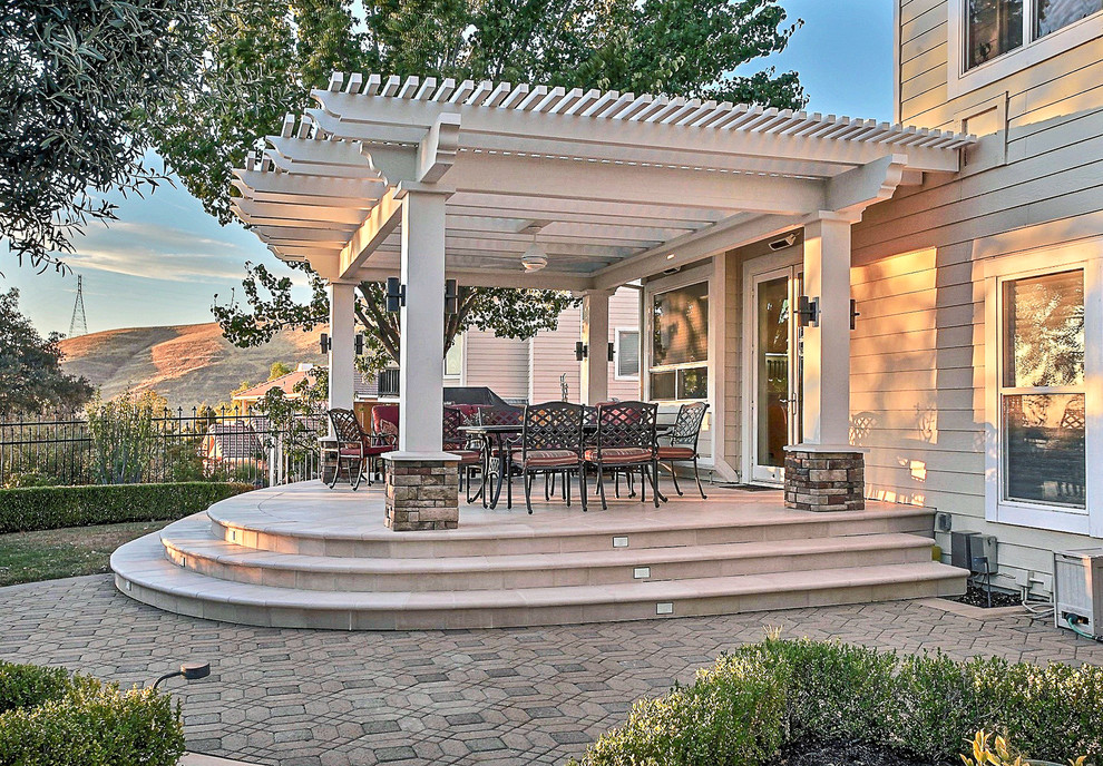 This is an example of a medium sized traditional back patio in San Francisco with a pergola and brick paving.
