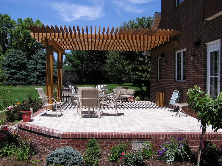 Photo of a large classic back patio in Chicago with an outdoor kitchen, a pergola and brick paving.