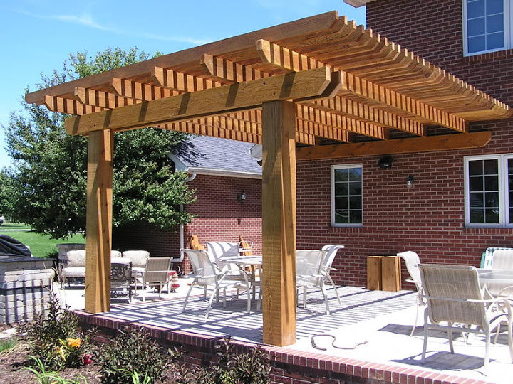 Design ideas for a large classic back patio in Chicago with an outdoor kitchen, brick paving and a pergola.