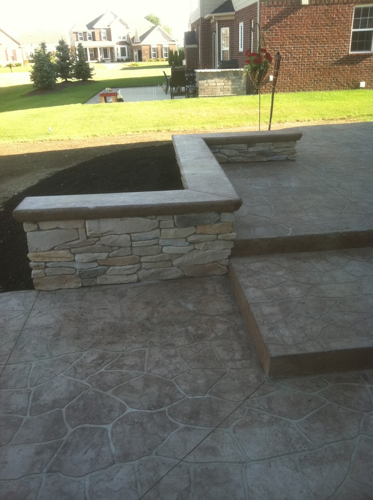 Medium sized contemporary back patio in Indianapolis with stamped concrete.