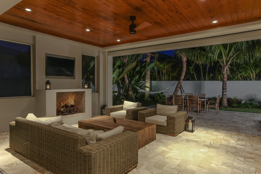 Inspiration for a world-inspired patio in Miami with a fire feature.
