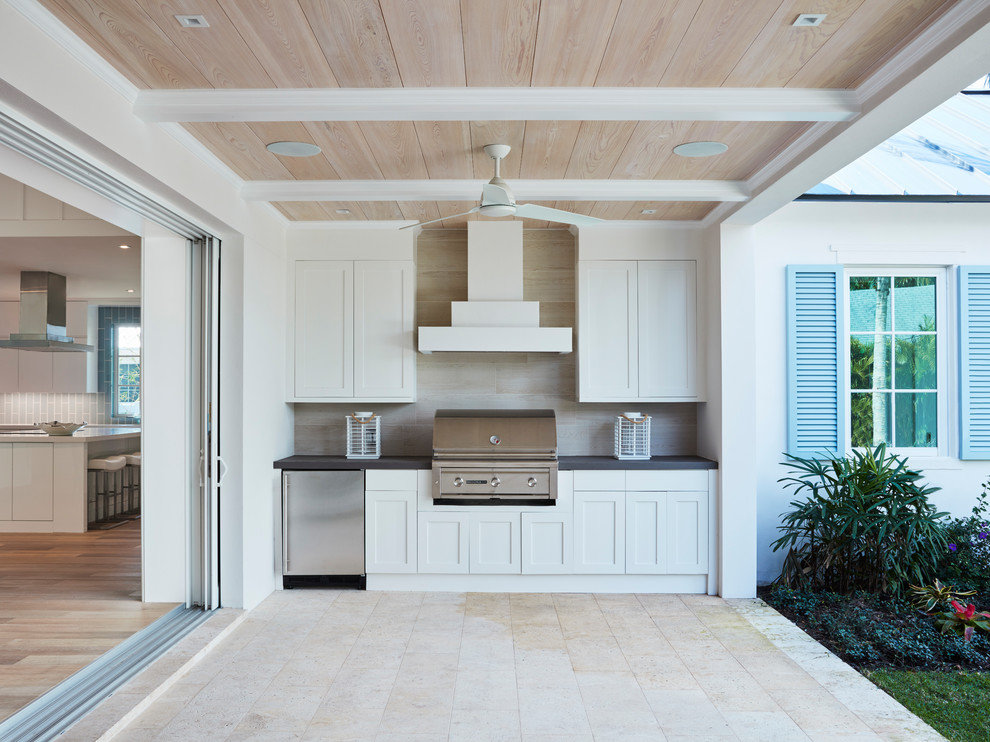 Example of a mid-sized trendy backyard tile patio kitchen design in Miami with a roof extension