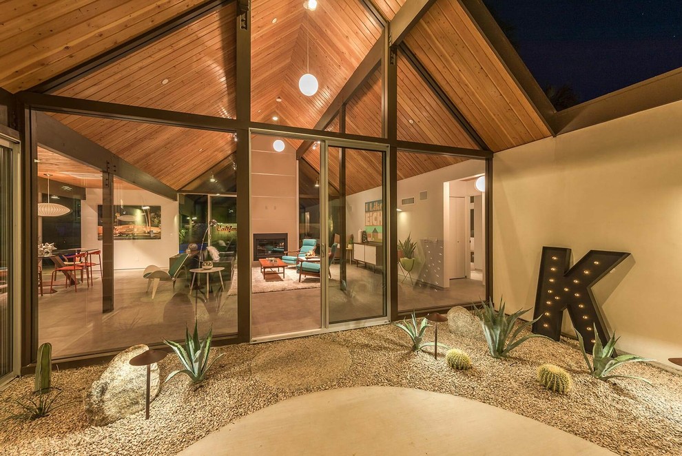 Ispirazione per un patio o portico minimalista di medie dimensioni e dietro casa con lastre di cemento