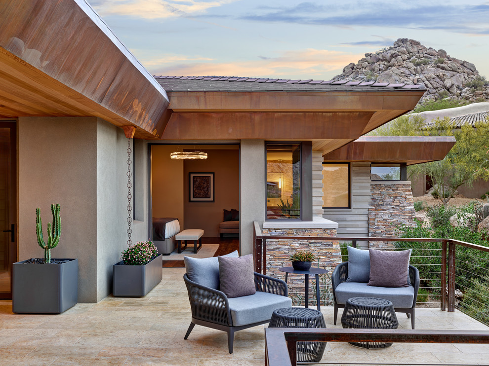 Patio - large transitional side yard patio idea in Phoenix with a fireplace and a roof extension