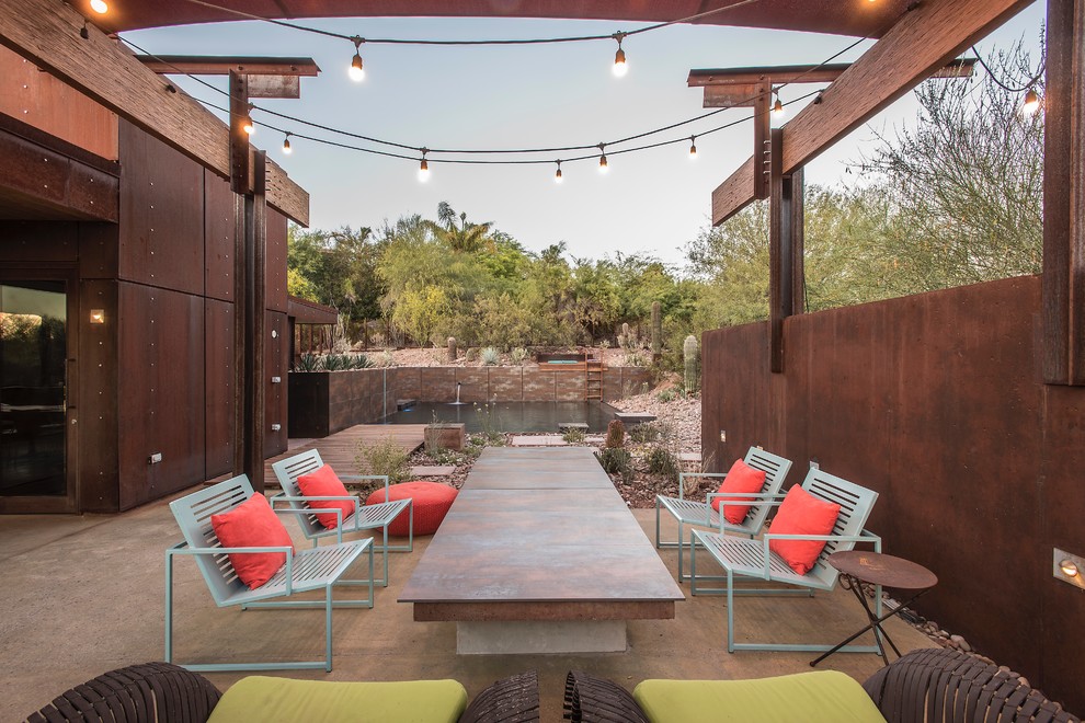 Design ideas for a large industrial back patio in Phoenix with no cover.