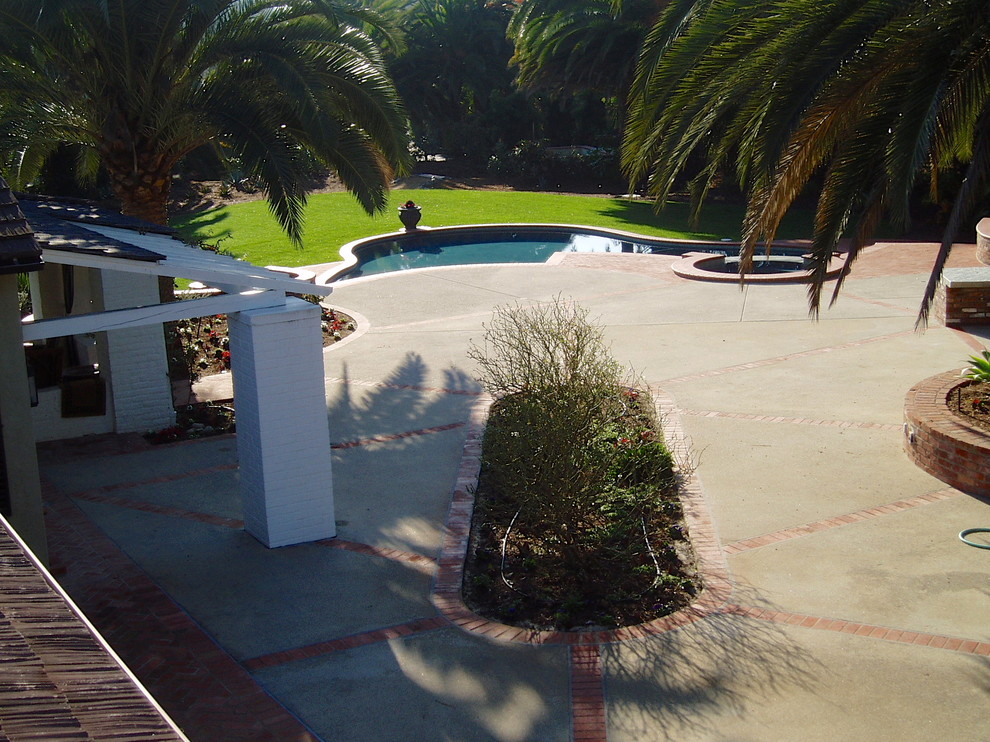 Design ideas for a large traditional back patio in San Diego with concrete paving.