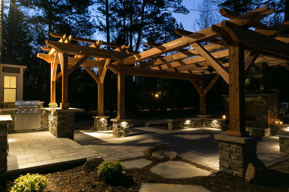 Inspiration for a medium sized traditional back patio in Charlotte with a fire feature, concrete paving and a pergola.