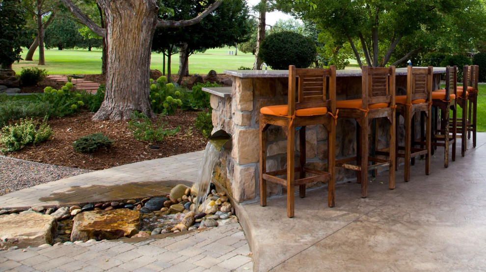 Design ideas for a medium sized traditional back patio in Denver with an outdoor kitchen and natural stone paving.