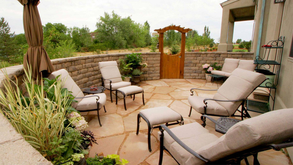 Small arts and crafts backyard stone patio photo in Denver with no cover