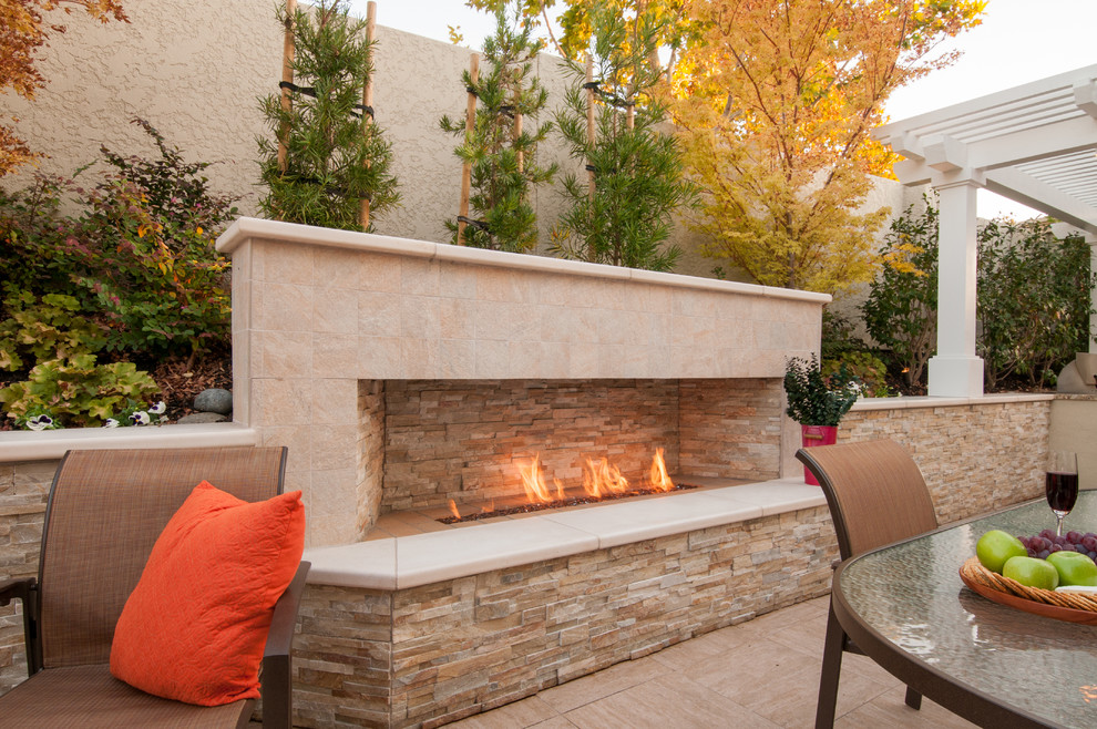 Inspiration for a large contemporary backyard tile patio remodel in San Francisco with a fire pit and a pergola
