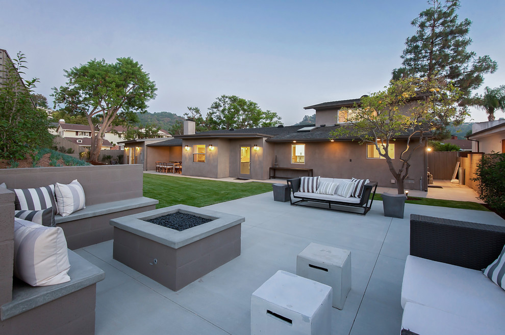 Inspiration for a transitional concrete patio remodel in Los Angeles with a fire pit and no cover
