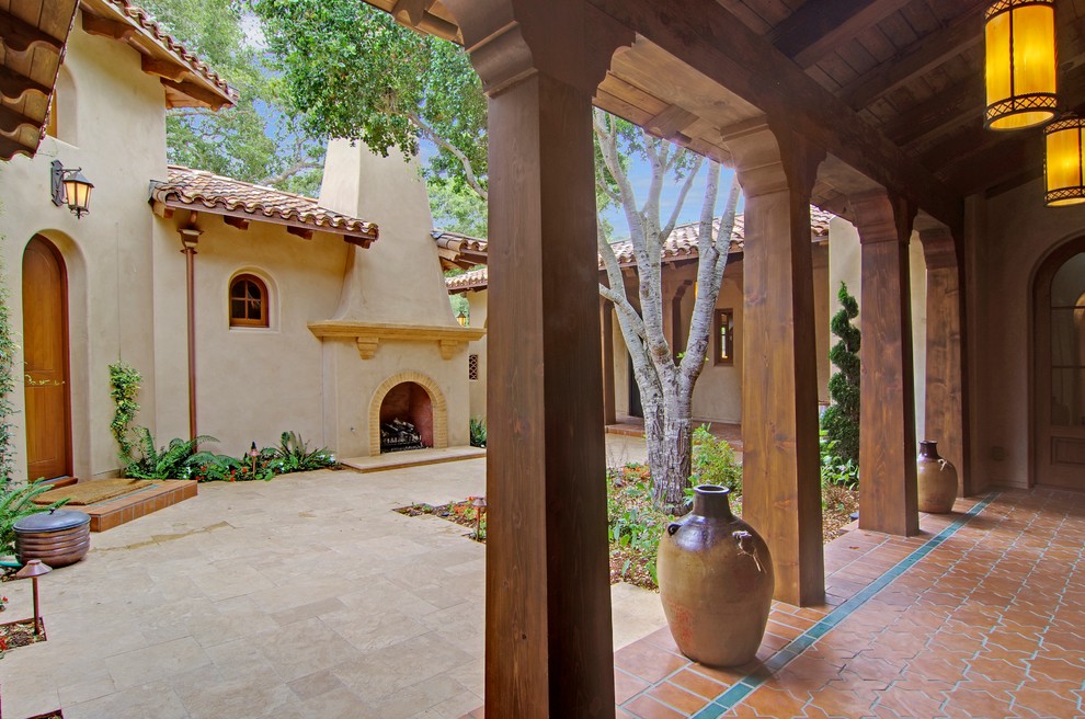 Foto di un patio o portico mediterraneo di medie dimensioni e dietro casa con fontane, lastre di cemento e una pergola