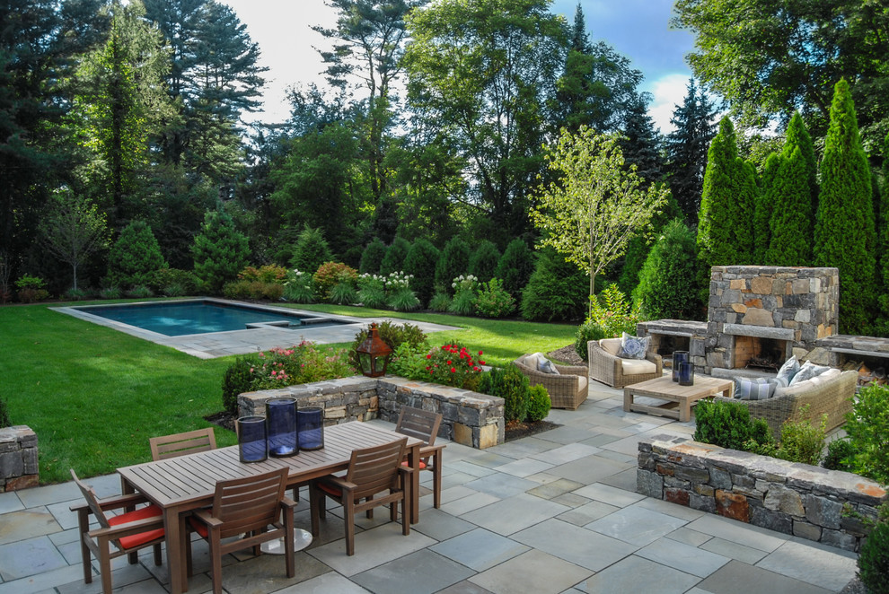 Patio - mid-sized traditional backyard stone patio idea in Boston with a fire pit