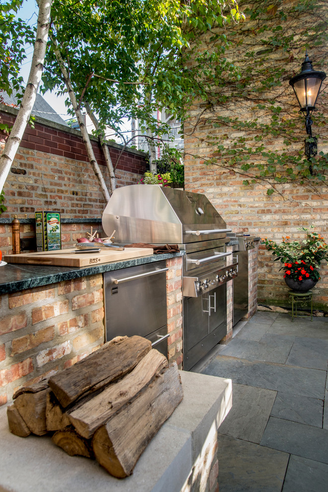 Medium sized traditional back patio in Chicago with an outdoor kitchen and no cover.