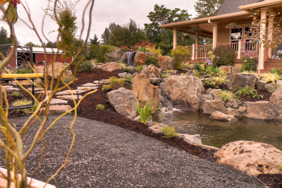 Dramatic pond with water fall Traditional Patio