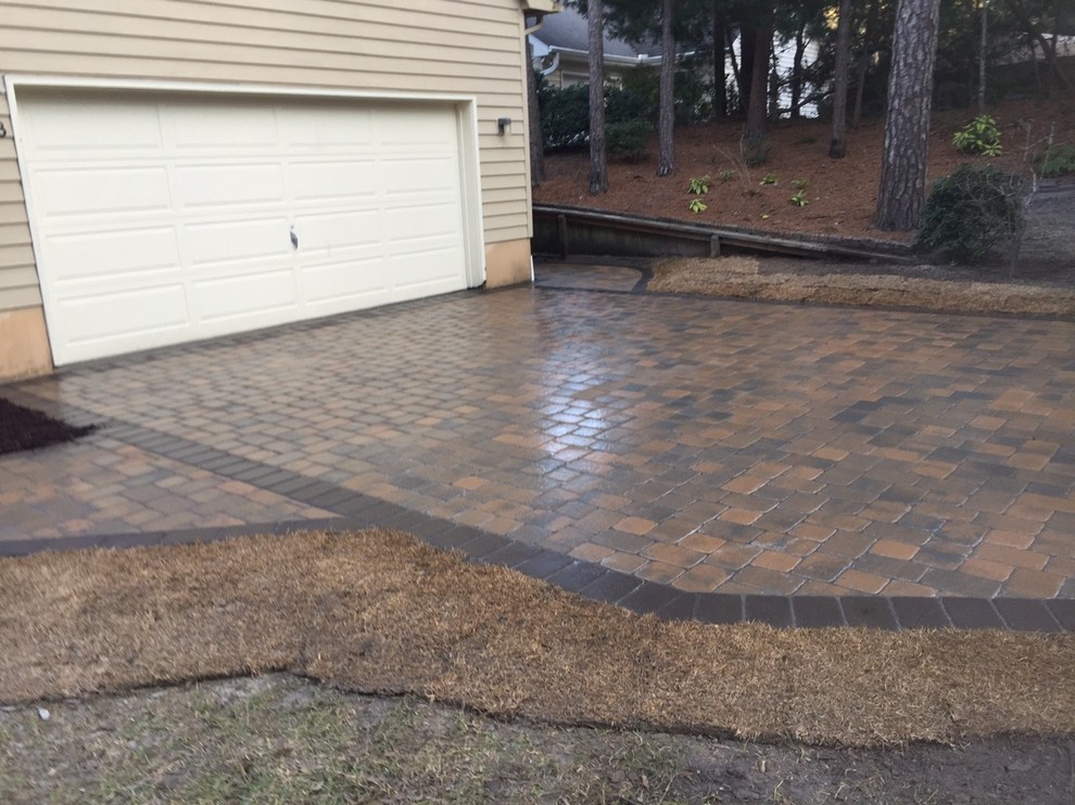 This is an example of a large nautical front patio in Other with concrete paving.