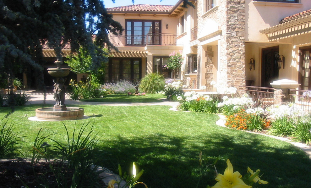 Large traditional courtyard patio in Boise with brick paving, a water feature and a pergola.