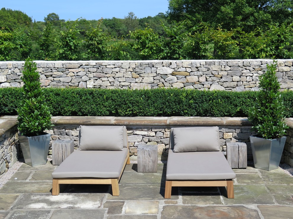 Inspiration for an expansive traditional back patio in West Midlands with natural stone paving.
