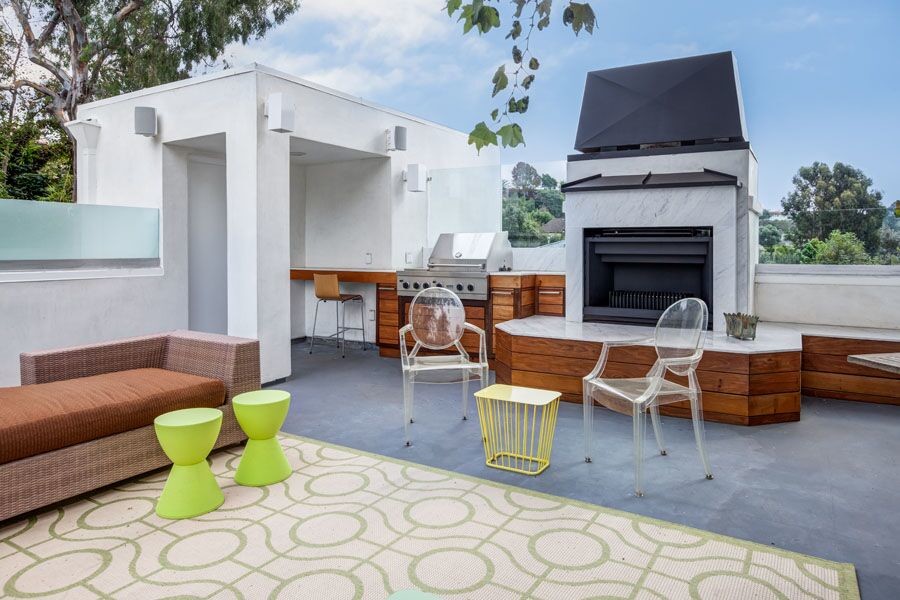 Example of a large transitional backyard concrete paver patio kitchen design in Los Angeles with no cover