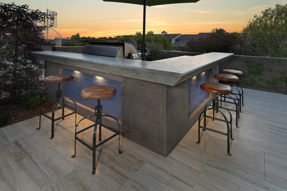 Example of a mid-sized trendy backyard stone patio kitchen design in Orange County