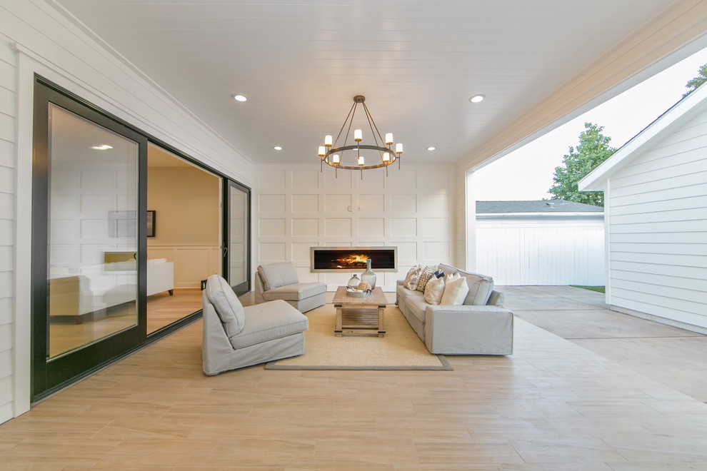 Example of a large arts and crafts backyard tile patio design in Orange County with a fire pit and a roof extension