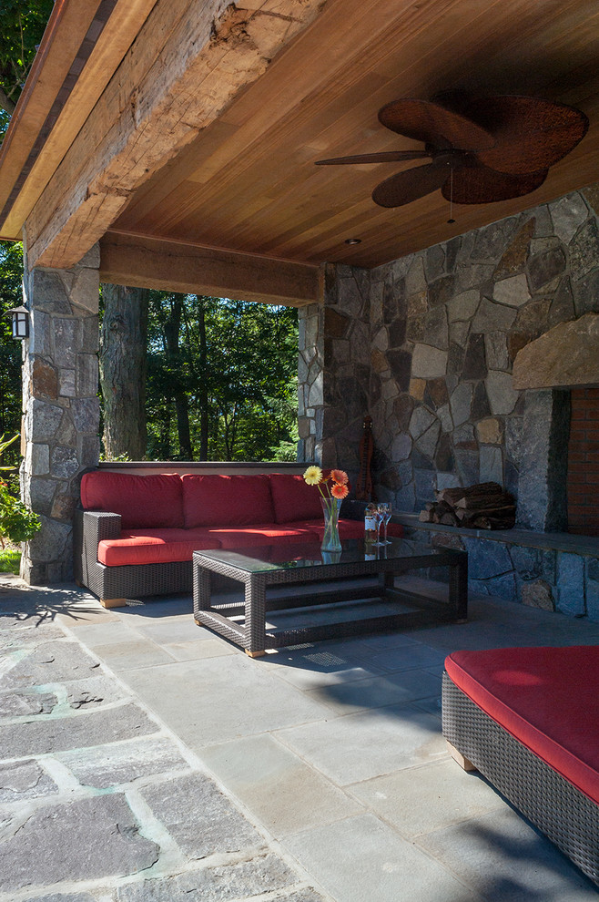 Large elegant backyard stone patio photo in New York
