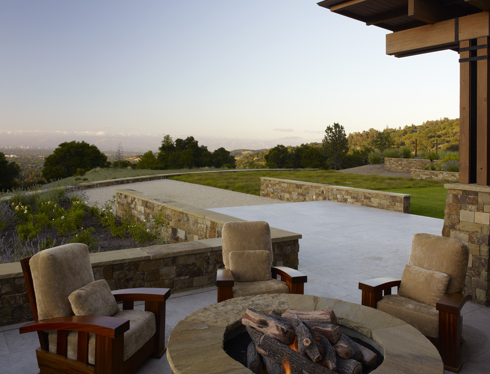 Patio - huge contemporary backyard stone patio idea in San Francisco with a fire pit and a roof extension