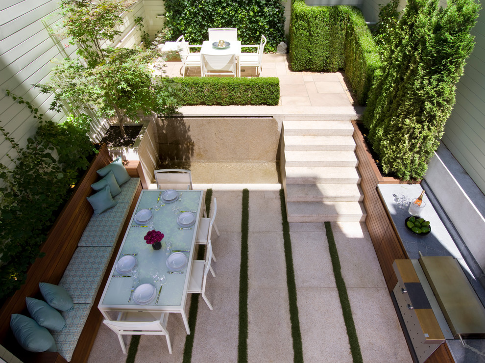 Idée de décoration pour une petite terrasse arrière design avec une cuisine d'été, une dalle de béton et aucune couverture.