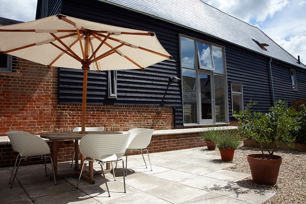 Photo of a medium sized eclectic courtyard patio in Essex with concrete paving.