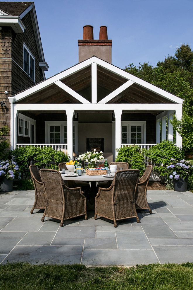 Huge beach style backyard stone patio container garden photo in New York with a roof extension